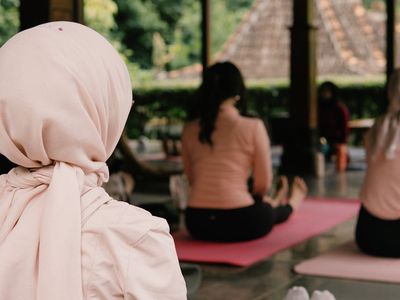 Healthy breakfast and water near a yoga mat.